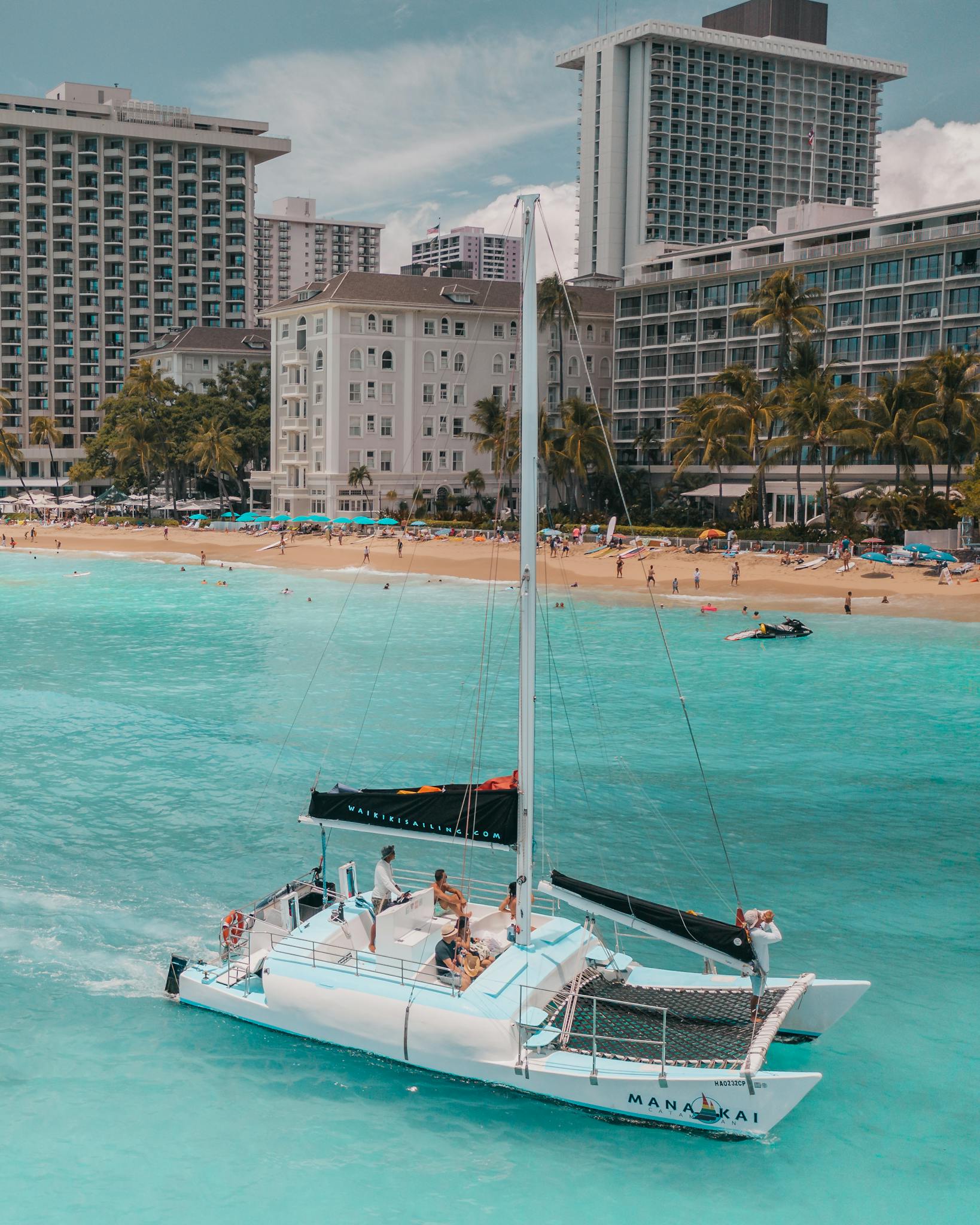 People Riding on White and Black Yacht on Sea